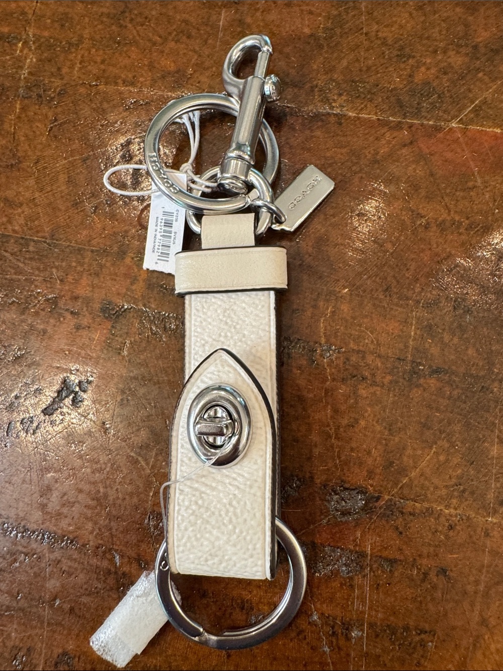Coach Cream Leather Turnlock Keyring with Silver Hardware